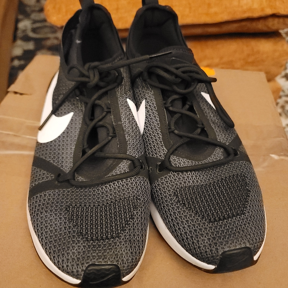 This is a pair of Nike Duel Racer sneakers in a black, white, and dark grey